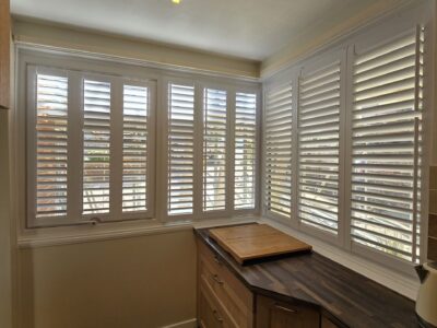 Roller blinds installed in a modern living room by JV Blinds