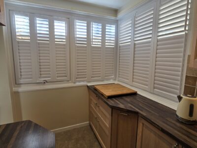 Full height shutters in a bedroom, installed by JV Blinds Eastbourne