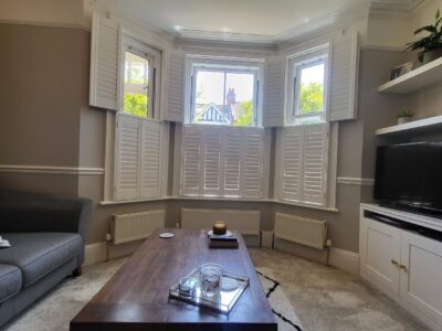 Shaped shutters on an arched window installed by JV Blinds