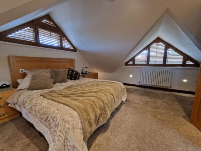 Blackout roller blinds in a bedroom fitted by JV Blinds