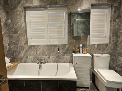 Shutters fitted on a large living room window by JV Blinds