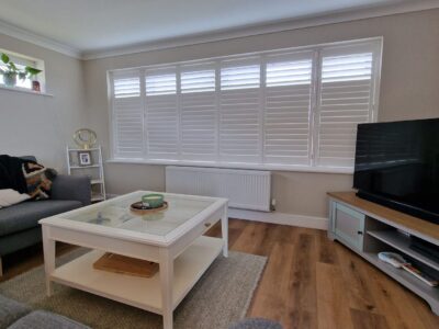 Wood venetian blinds adding warmth to a living room by JV Blinds