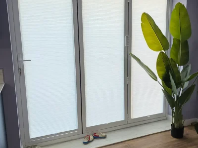 Light filtering honeycombe pleated blind installed onto bifold doors